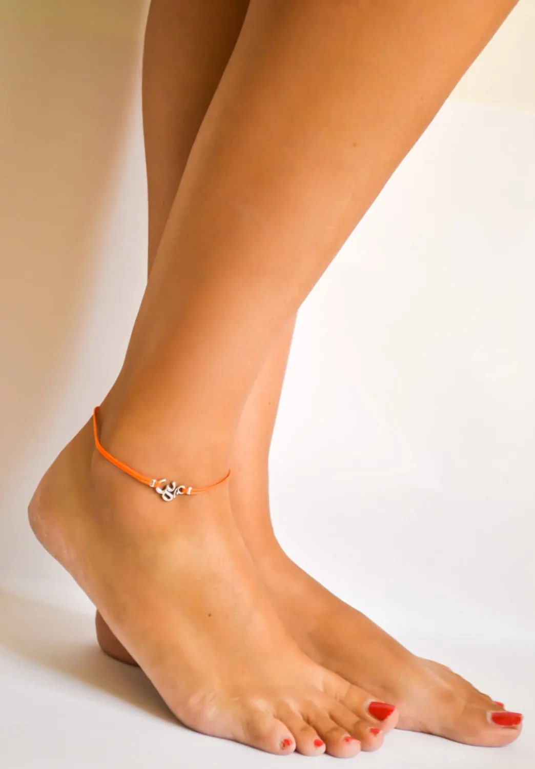 Orange cord anklet with silver Om charm, yoga jewelry